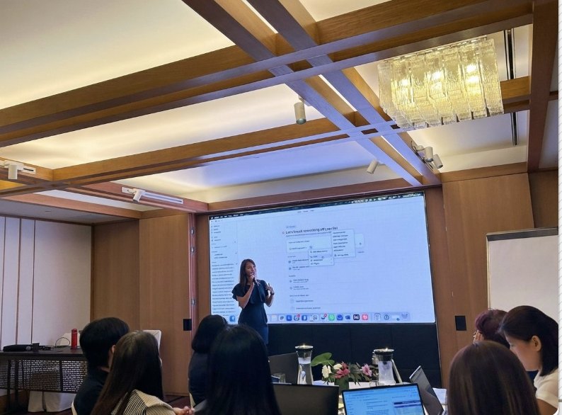Photograph of the retreat room at the BNF Group strategy retreat, Ritz-Carlton Singapore, 30 March 2026, where Geargina Tan (Coach Gina) ran a 3 hr Claude workshop for 40+ senior managers. Real photo, attendees seen from behind. AI training for teams in Singapore.