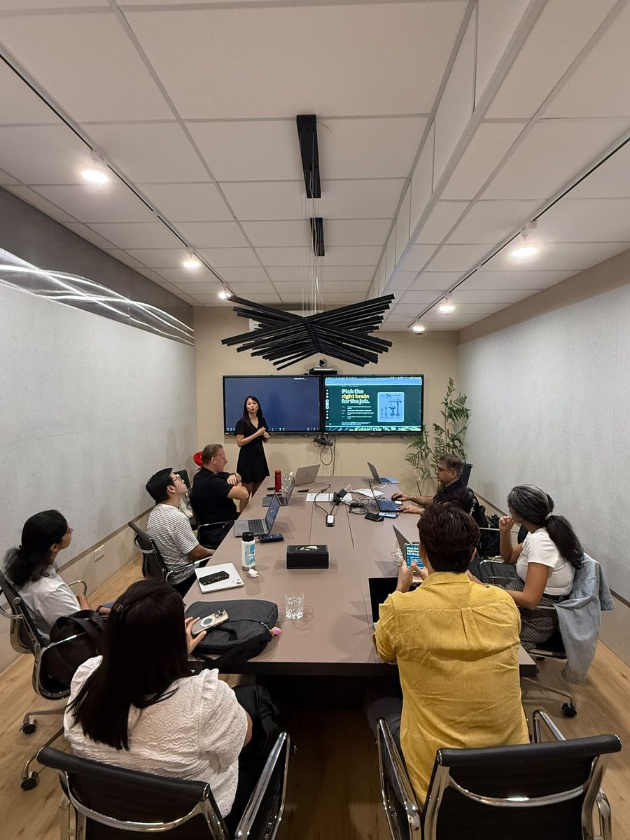 Attendees at the Claude Masterclass 101 run by Geargina Tan (Coach Gina) with Cogentic AI Partners, SQ Collective, Singapore, August 2026. Real photo, taken from behind the room during a hands-on build block. Claude workshop in Singapore.