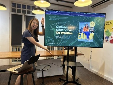 Photograph of Geargina Tan (Coach Gina), AI workshop facilitator in Singapore, at the screen opening the Podium Insight Hour session for women professionals, 18 June 2026. Real photo. AI training for teams and communities in Singapore.